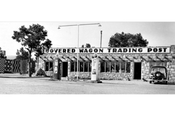 black and white image of covered wageon trading post